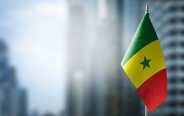 A small flag of Senegal on the background of a blurred background