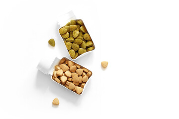 dietary supplement in a white plastic container, multicolored vitamins pills on a white background