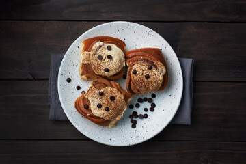 Kanelbulle Cinnamon buns with buttercream on a rustic wooden table. Homemade fresh pastries.