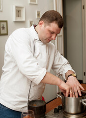male chef with cooked food standing in the kitchen.