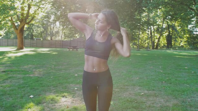 fitness girl incredible abs aranging hair slow mo steadicam cinematic sun flair