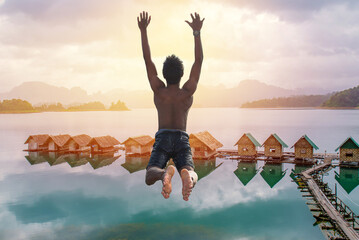 Man jumping into lake or river. freedom concept, Flying freely to the sky. Summer vacation lifestyle