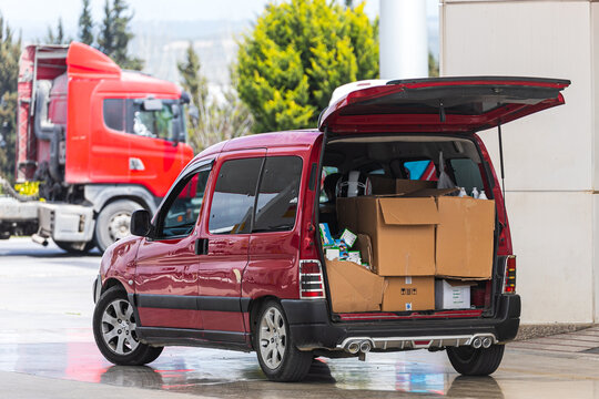 Station Wagon With Open Trunk Stands Prepared For Unloading Boxes On The Parking Lot