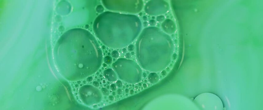 Macro Textures with Vibrant Neon Color Palette. Abstract Background Made with Oil Mixed with Green Dye, Ink, and Paint.