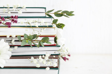 Books with floral decor on white background