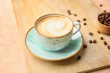 Cup of hot cappuccino coffee on table