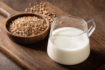 buckwheat and buckwheat milk on a wooden kitchen board, gluten-free.