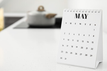 Flip paper calendar on table in kitchen