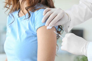 Doctor vaccinating patient against covid-19 in clinic © Pixel-Shot