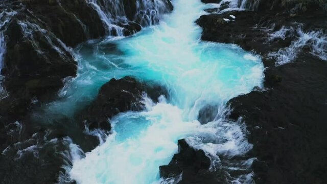 Reveal Shot Of The Beautiful Bruarfoss Waterfall On Bruara River In Iceland - aerial tilt up