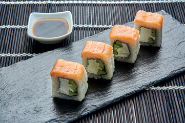 Philadelphia roll classic dark stone on the Board. Japanese sushi.