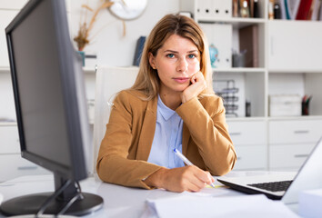 heavy female manager working in white room