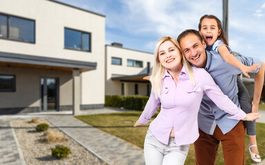 Happy family. family on the background of a new house. Modern new house is on the background.