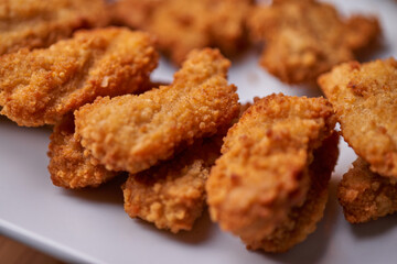 macro closeup of chicken nuggets snacks on white plate