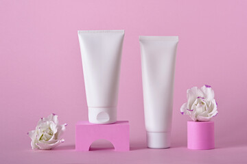 Obraz na płótnie Canvas Beauty natural skincare product mock up. Cream tubes and flowers on different geometric podiums. Body Skincare products presentation