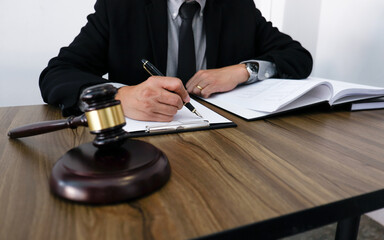 Lawyer Legal counsel presents to the client a signed contract with gavel and legal law. justice and lawyer Business partnership meeting concept.