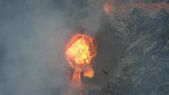 Aerial top down view over active, hot and continuous volcanic eruption in Iceland.