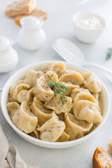 Handmade dumplings with meat, traditional Russian cuisine, selective focus