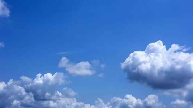 Time lapse of the serene blue sky is adorned with puffy, fluffy white clouds, creating a mesmerizing cumulus cloud cloudscape.