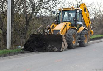 excavator works on road repair