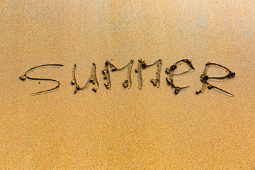 inscription on the wet sand near the sea or lake.