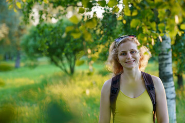 beautiful girl with curly white hair, happy walk in the park on a sunny day.