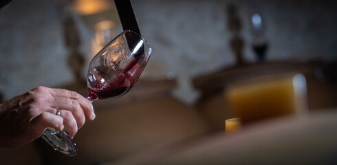 FRANCE, GIRONDE, SAINT-EMILION, SAMPLING A GLASS OF WINE IN A BARREL WITH A PIPETTE FOR TASTING AND VINIFICATION MONITORING, HIGHT QUALITY PHOTO