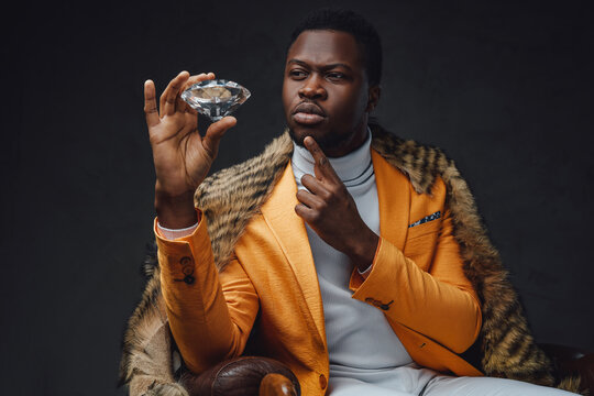 Pensive Black Man With Fur Holding Diamond