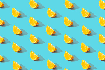 Fruit pattern of fresh orange tangerine or mandarin on blue background. Pop art design, creative summer concept. Citrus in minimal style.