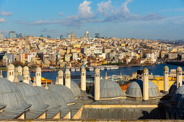 Fototapeta na wymiar Picturesque view of Beyoglu district across Golden Horn Bay from ancient Suleymaniye Mosque in Istanbul on sunny winter day, Turkey