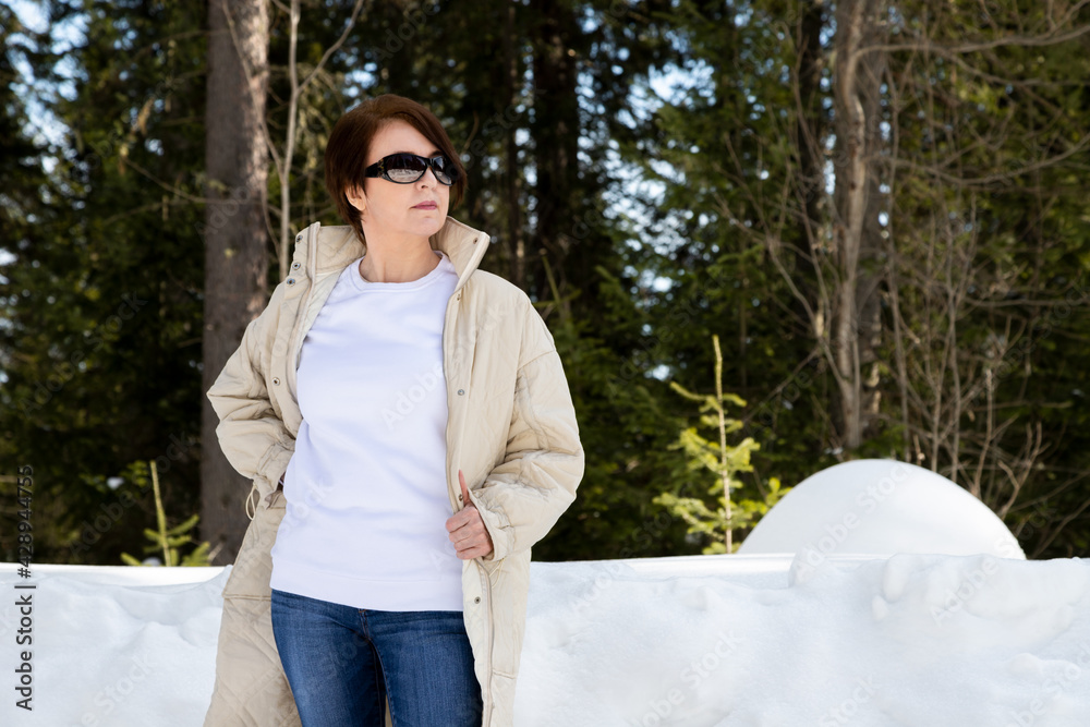 Wall mural White sweatshirt mockup of a woman in beige coat