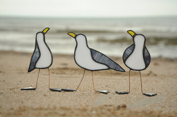 glass seagulls standing on a coastal beach