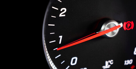 Close up shot of a tachometer in a car. Car dashboard. Dashboard details with indication lamps. Car instrument panel. Dashboard with tachometer, odometer. Car inside