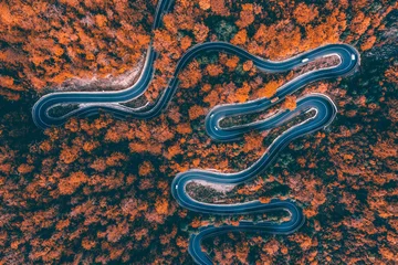 Foto op Aluminium Aerial view of road in beautiful autumn forest at sunset. © erika8213
