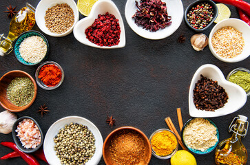 Various spices in a bowls on a black