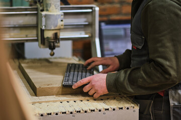 Milling a wooden board. Processing of wood panels on CNC coordinate milling woodworking machines. Slow motion video. Sawdust scatter in different directions