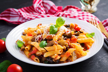 Pasta penne with eggplant. Pasta alla norma - traditional Italian food with eggplant, tomato, ricotta cheese and basil.