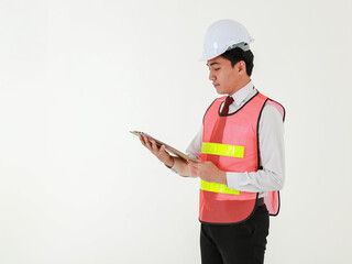 An asian architectural engineer in white shirt red tie wearing white safety hard hat holding a clipboard with documents to checking the project, standing on white background.