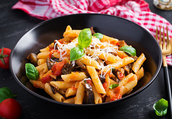 Pasta penne with eggplant. Pasta alla norma - traditional Italian food with eggplant, tomato, ricotta cheese and basil.