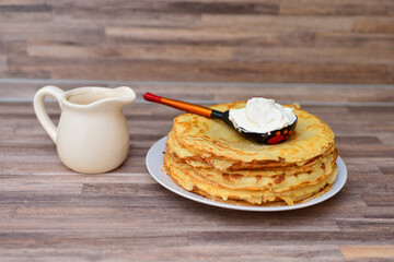 stack of pancakes with sour cream