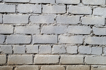 Rough, dirty gray brick wall.