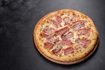 Delicious fresh crispy pizza from the oven with ham, cheese and basil