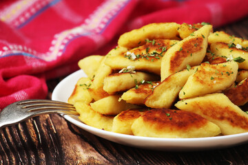 Polish dish kopytka served at the table