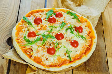 Round pizza with cheese and tomatoes.