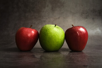 three apples on a dark background