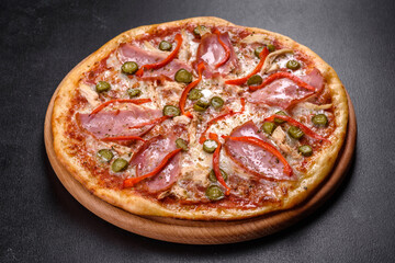 Delicious fresh crispy pizza from the oven with ham and Bulgarian pepper