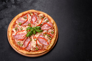 Delicious fresh crispy pizza from the oven with ham and Bulgarian pepper