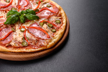 Delicious fresh crispy pizza from the oven with ham and Bulgarian pepper
