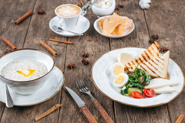 Table served with breakfast of fried eggs and porridge