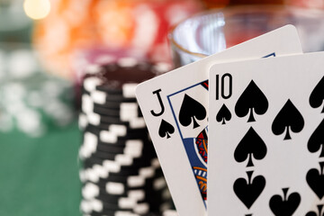 Playing cards on poker table background close up